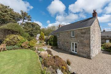 The pretty cottage is set in acres of garden.