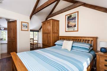 This master bedroom has views over the beautiful gardens.