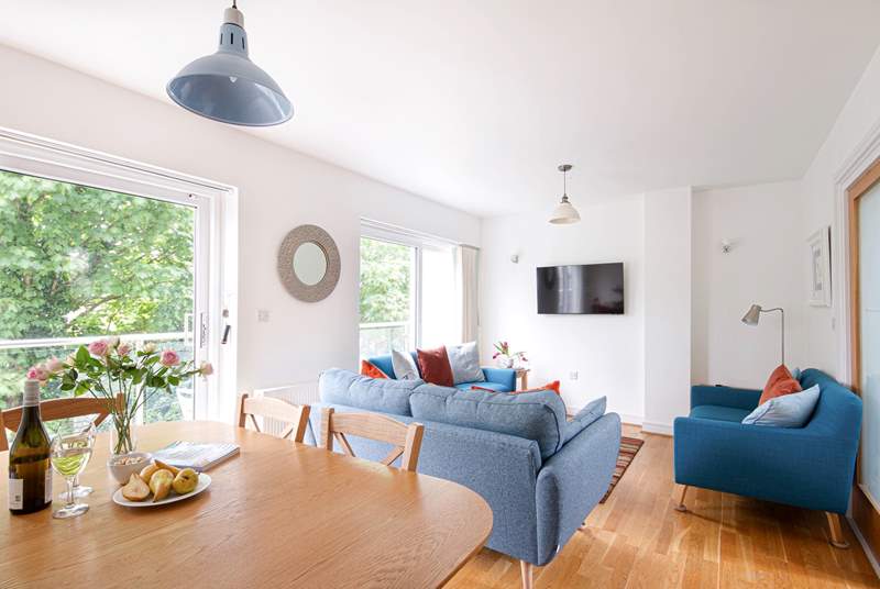 The open plan living space is lovely and sociable, with doors that open up to the balcony. 