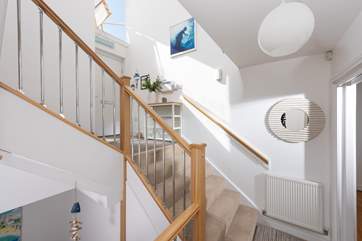 The light and airy landing area awaits you as you enter through the front door. beautiful art hangs on the walls and tasteful touches all around.