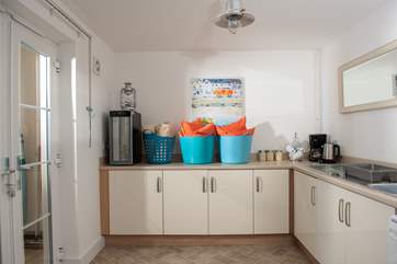 The utility-room, which leads out to the lovely large patio area, is very useful with extra tea and coffee making facilities and a wine cooler. Outdoor cushions and throws are provided for that added comfort!