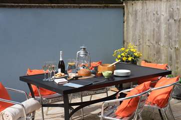 Alfresco dining is a joy in the sheltered outside space.