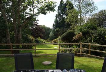 The view across the lovely garden is enhanced by mature shrubs and trees which offer seclusion and tranquility.
