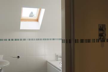 The family bathroom has a shower cubicle and bath.