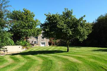 The well-kept garden is huge, with plenty of space for children to play.