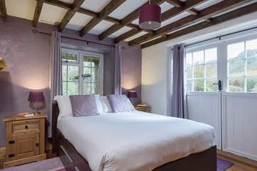Bedroom 2 is furnished with a double bed and a TV/DVD player, and has lovely views across the garden.