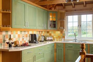The spacious kitchen has wonderful views across the surrounding gardens.