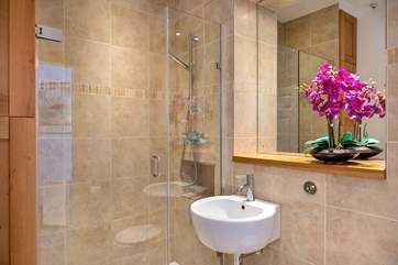 A luxurious large shower can be found in the bathroom.