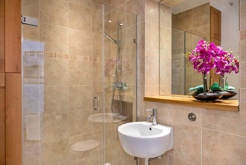 A luxurious large shower can be found in the bathroom. 