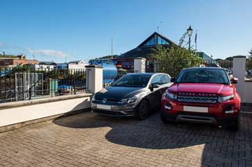 The car parking space is parallel to the wall and is suitable for a small/medium car (where the VW is parked).