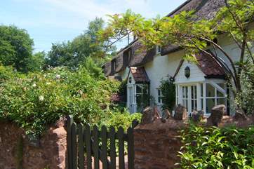 A little garden gate leads to the front door - there are two porches opening out onto the garden, the second is from the sitting-room.