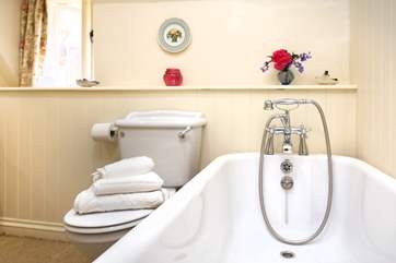 The family bathroom is upstairs too with a bath and hand-held shower attachment. This room looks out over the pretty back garden.