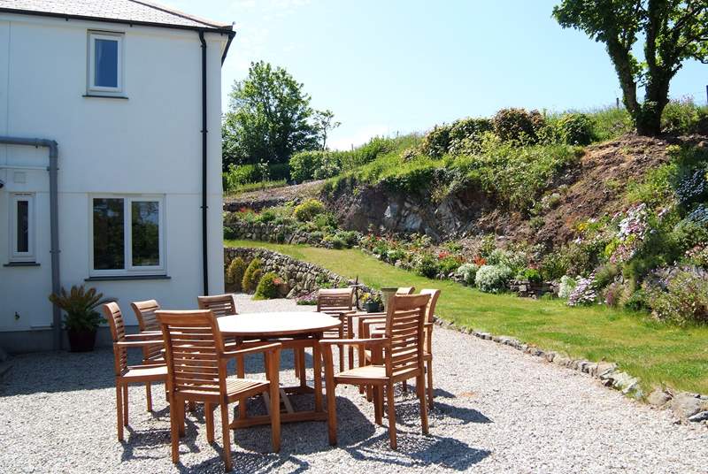 The gravelled patio is a sunny, sheltered spot ideal for enjoying meals outside.