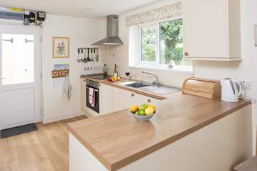 The well-equipped kitchen looks over the lane towards the village.