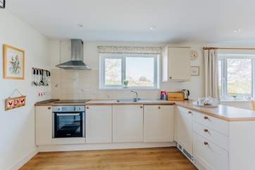 The well-equipped kitchen looks over the lane towards the village.