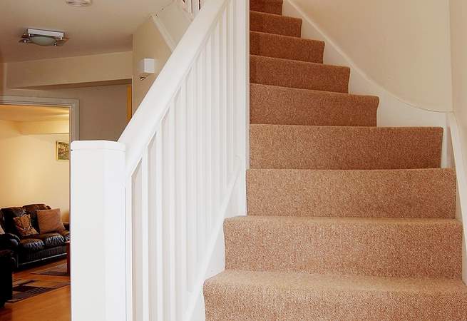 The staircase leads from the hall up to the first floor bedrooms.