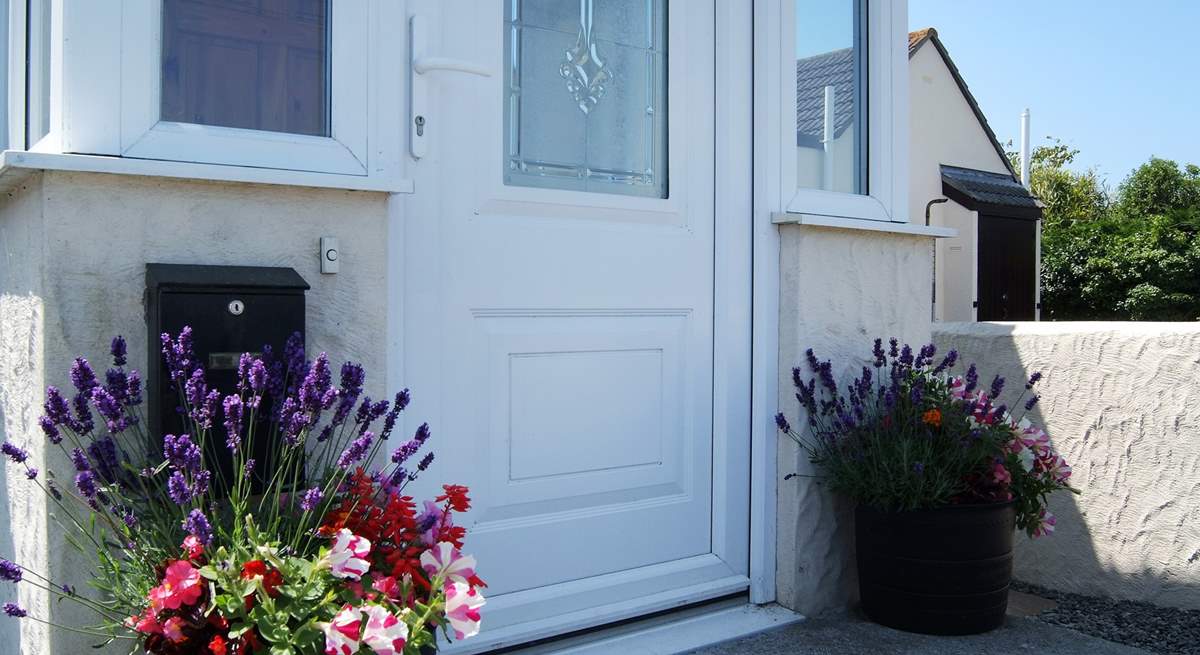 In summer there are colourful pots of flowers either side of the front door.