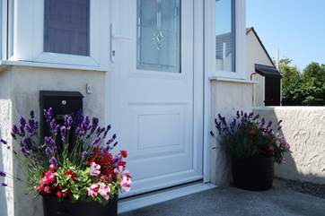 In summer there are colourful pots of flowers either side of the front door.