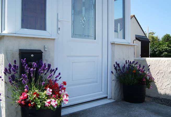 In summer there are colourful pots of flowers either side of the front door.