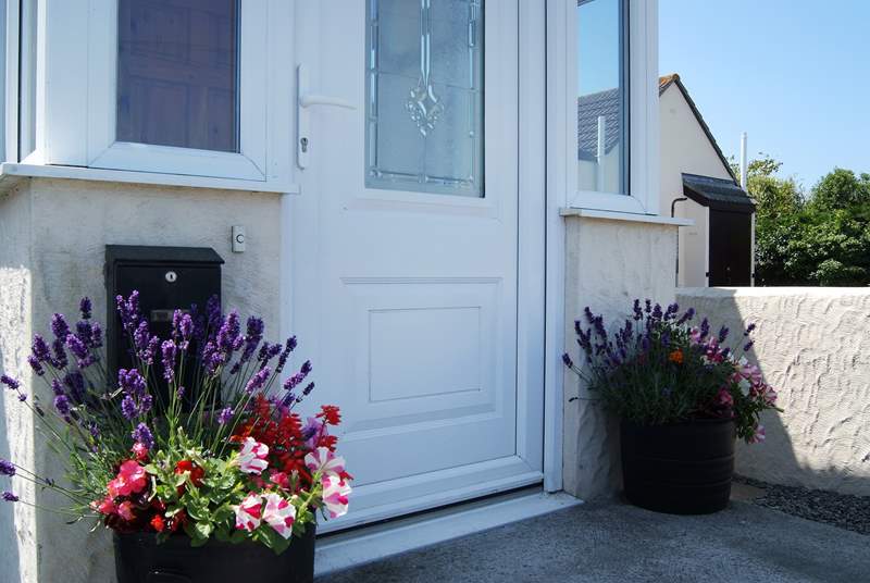 In summer there are colourful pots of flowers either side of the front door.