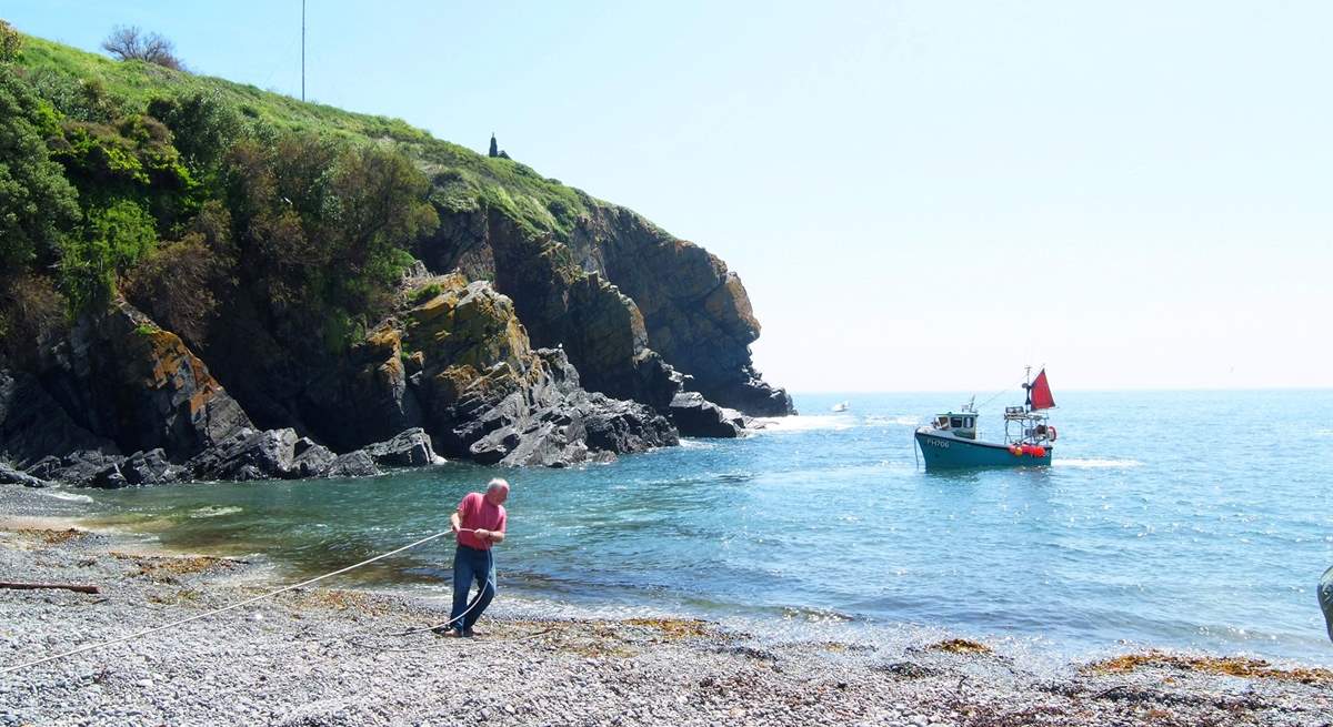 Working fishing boats come and go with the tides.