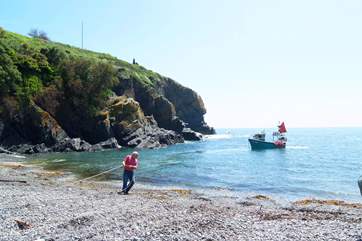 Working fishing boats come and go with the tides.
