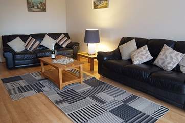 Two, three seater sofas and a chair means there is room for everyone to relax in front of the TV or for a chess challenge!