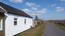 Sea Cottage is in a unique position with direct access to the beach and the Tarka Cycle Trail, with the local cricket club and access lane to the cottage on the other side of the cottage.