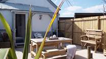 Looking back towards the cottage from the sheltered garden with open views to one side. There is an area of lawn as well.