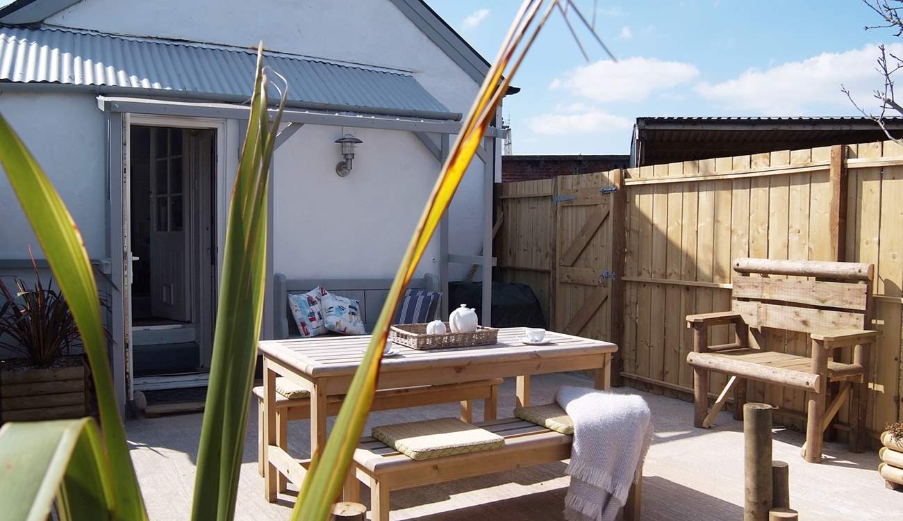Looking back towards the cottage from the sheltered garden with open views to one side. There is an area of lawn as well.
