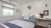 The main bedroom with its comfortable bed and pretty furnishings. This room looks out over the Tarka Trail.