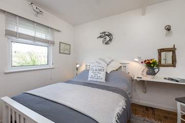 The main bedroom with its comfortable bed and pretty furnishings. This room looks out over the Tarka Trail.