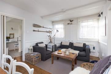 There is plenty of comfortable seating for all in this bright and tasteful room.