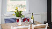 There is a pretty little farmhouse table.