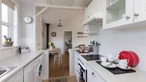 The galley-style kitchen is extremely well-equipped and leads through into the main living-area.