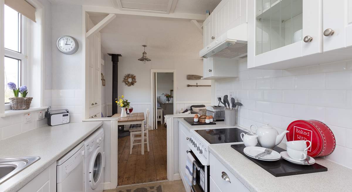 The galley-style kitchen is extremely well-equipped and leads through into the main living-area.