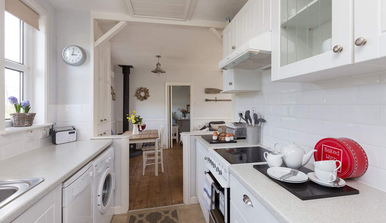 The galley-style kitchen is extremely well-equipped and leads through into the main living-area.