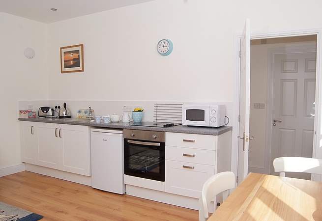 The kitchen-area, cleverly fitted along one wall of the open plan living area.
