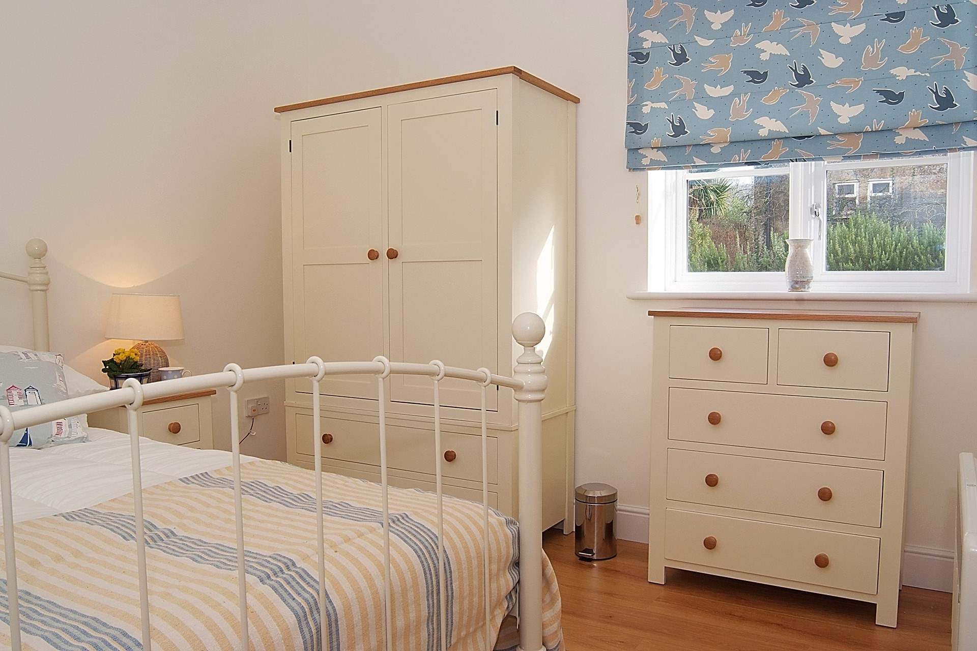 The bedroom has a king-size bed and is beautifully decorated with plenty of storage.