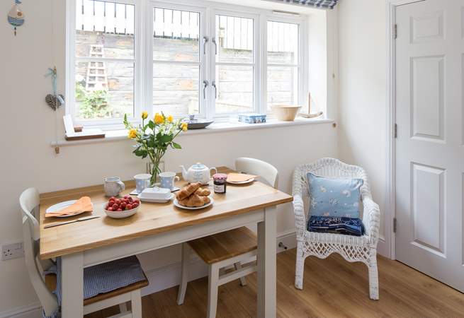 The dining-table sits to one side of the open plan living space, enjoy eating some local produce in this beautiful part of Dorset.
