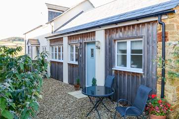 The Linhay snuggles behind The Parlour, in a sheltered courtyard, with views of Golden Cap.