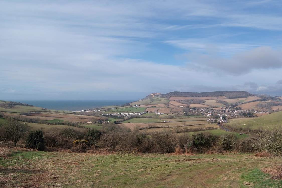The Parlour is in the nearest cluster of buildings to the left of the photograph, Golden Cap is beyond and Chideock village is to the right.