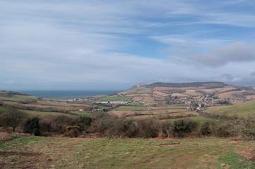 The Parlour is in the nearest cluster of buildings to the left of the photograph, Golden Cap is beyond and Chideock village is to the right.