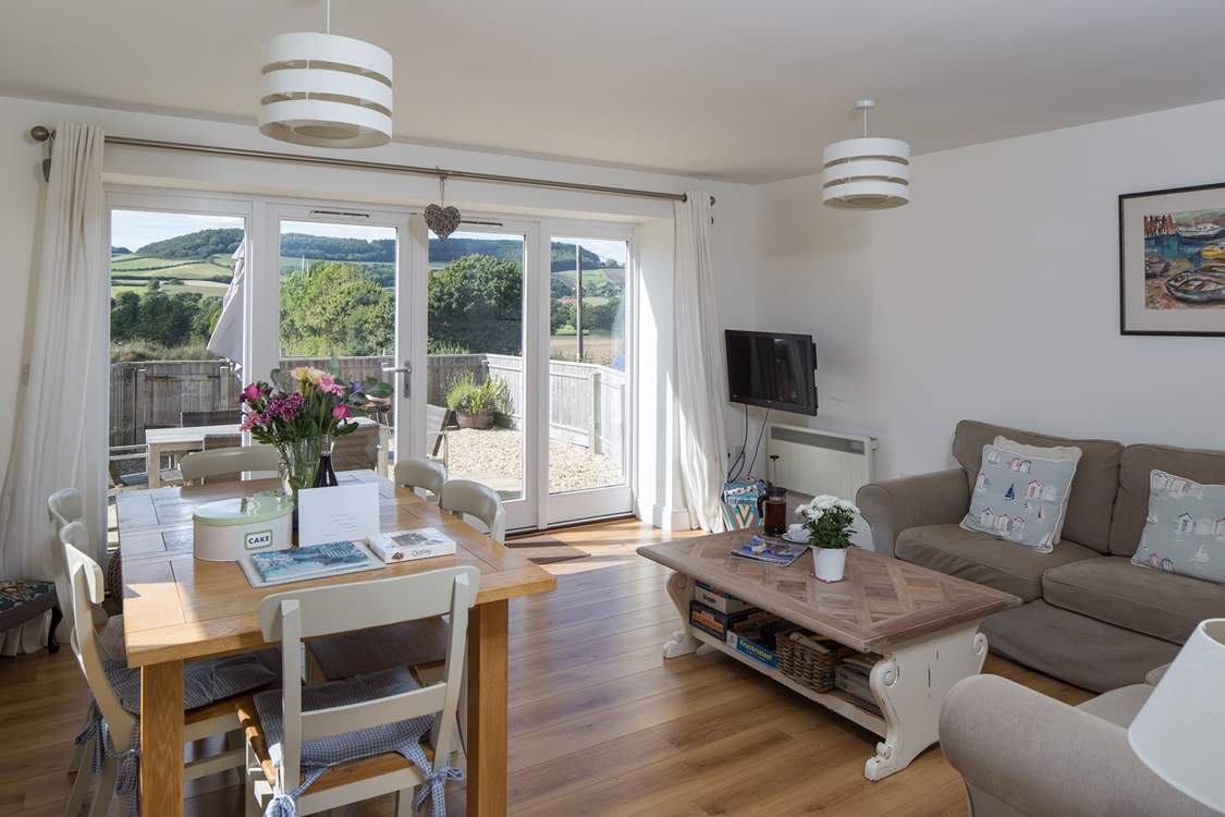 The comfortable living/dining-area has French doors that really celebrate the view.