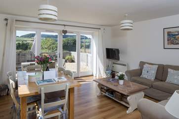 The comfortable living/dining-area has French doors that really celebrate the view.
