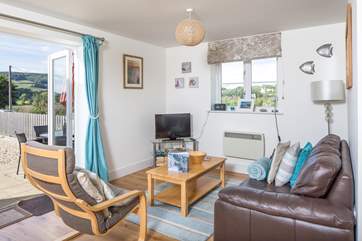 This welcoming open plan living-area has French doors straight out onto the enclosed patio.