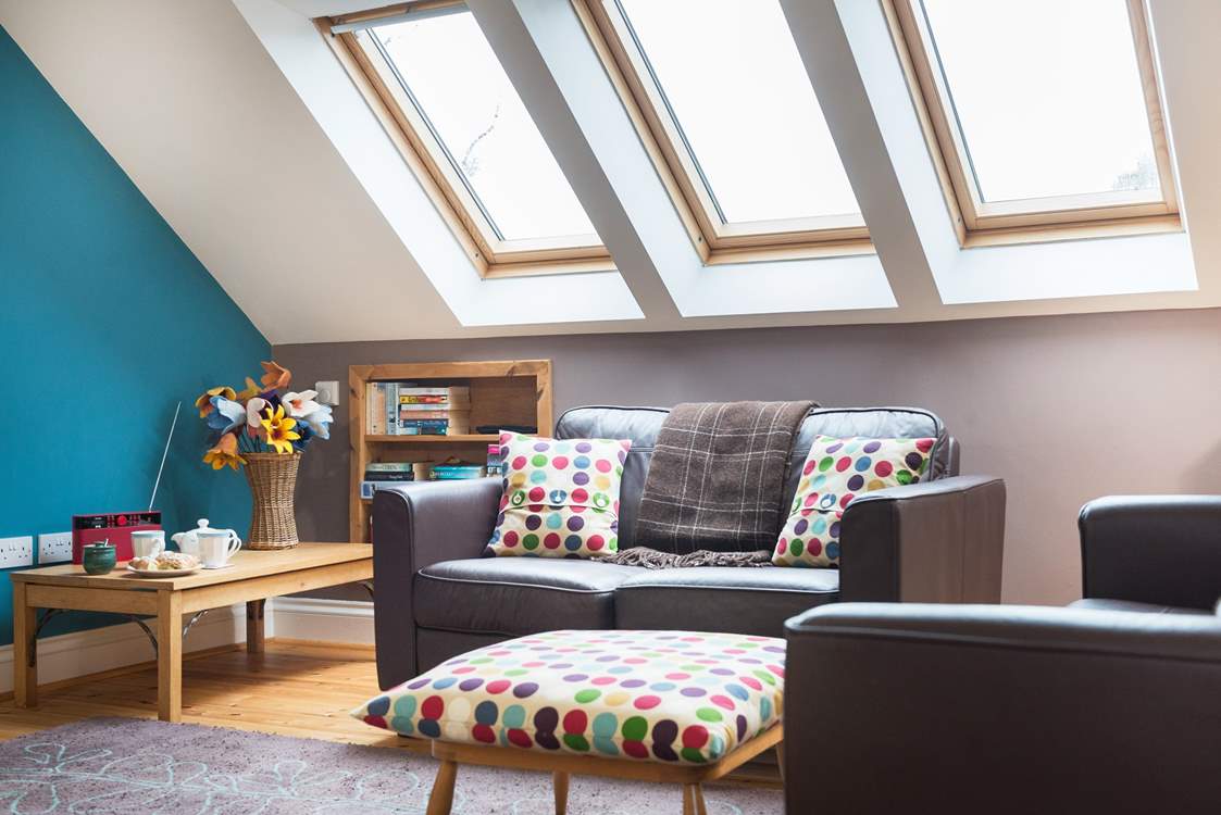 Velux windows on both sides of the open-plan living-room allow light to flood in.