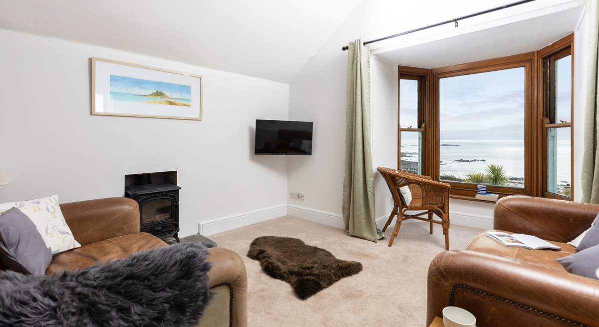 The living area is on the first floor to make the most of the captivating views. Please note, the wood-burner is ornamental.