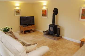 Comfortable sofas surround the wood-burner.