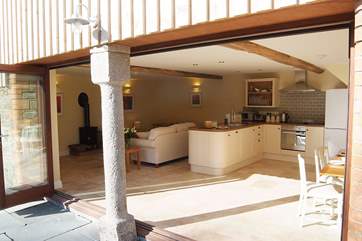 A view from the garden towards the open plan living-room - the bi-fold doors allowing sunshine to flood through.